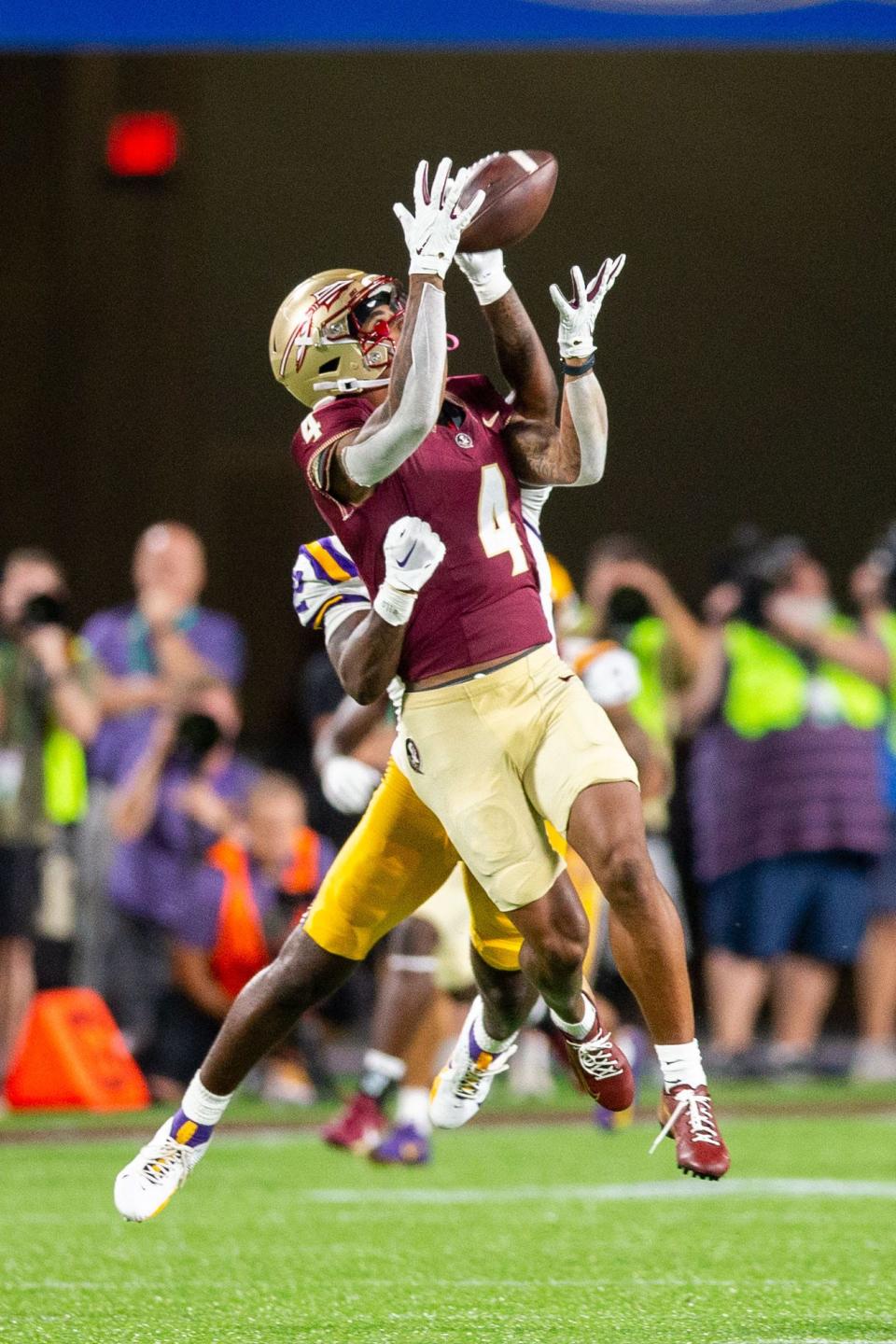 Florida State Seminoles wide receiver Keon Coleman (4) catches a pass from Florida State Seminoles quarterback Jordan Travis (13) during a game against the LSU Tigers at Camping World Stadium on Sunday, Sept. 3, 2023.