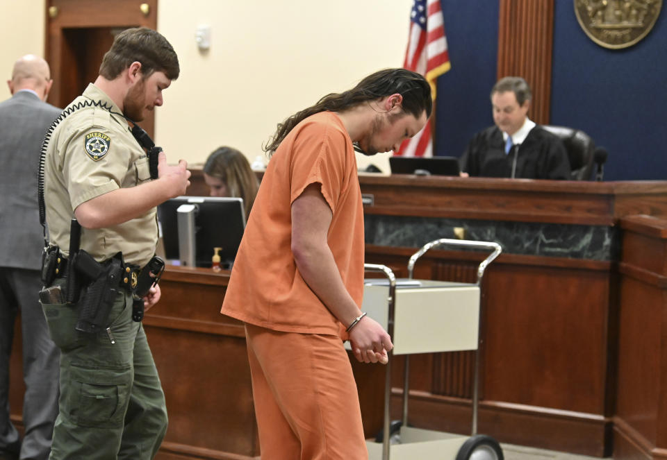 Jacob Kaderli is escorted out after Judge Jack Niedrach denied a bond at Floyd County Superior Court in Rome, Ga., on Friday, Feb. 14, 2020. Bond was denied Friday for two Georgia men, 19-year-old Kaderli of Dacula and 25-year-old Michael Helterbrand of Dalton, authorities say are linked to a violent white supremacist group known as The Base. (Hyosub Shin/Atlanta Journal-Constitution via AP)