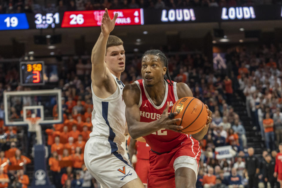 Houston guard Tramon Mark (12) move past a Virginia defender during the first half of an NCAA college basketball game in Charlottesville, Va., Saturday, Dec. 17, 2022. (AP Photo/Erin Edgerton)