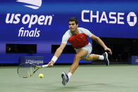 Carlos Alcaraz, of Spain, returns a shot to Casper Ruud, of Norway, during the men's singles final of the U.S. Open tennis championships, Sunday, Sept. 11, 2022, in New York. (AP Photo/Charles Krupa)