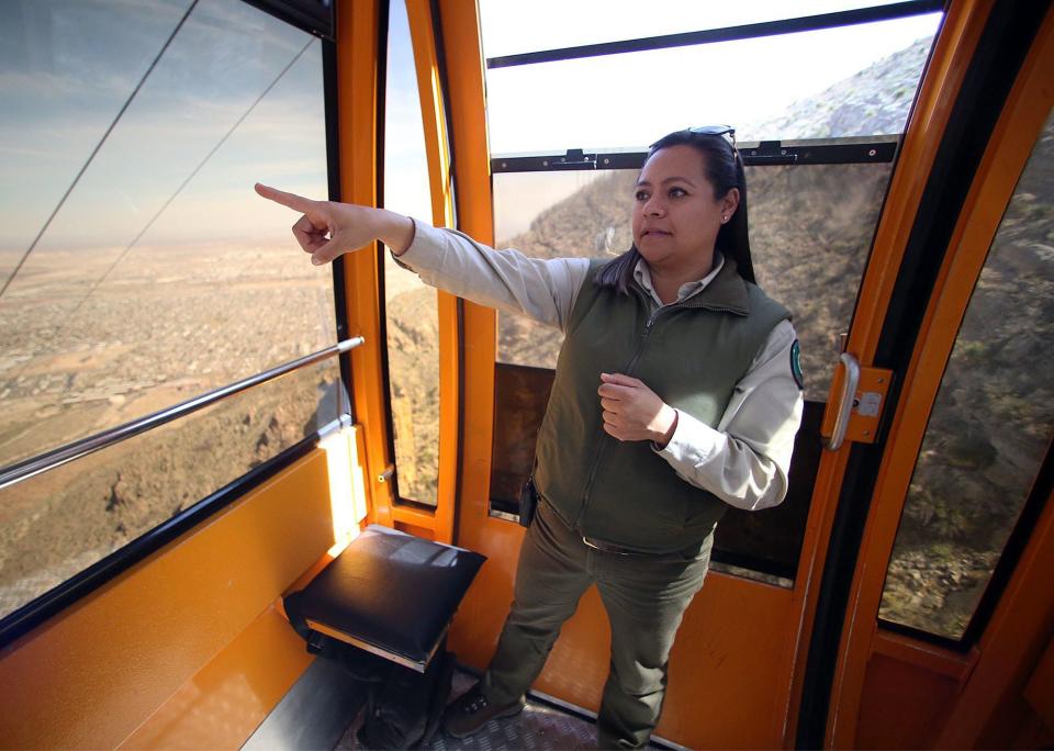 Diana Moy, park interpreter at the Wyler Aerial Tramway, points out features while riding the cable car down from the scenic area atop the Franklin Mountains Sept. 19, 2018.