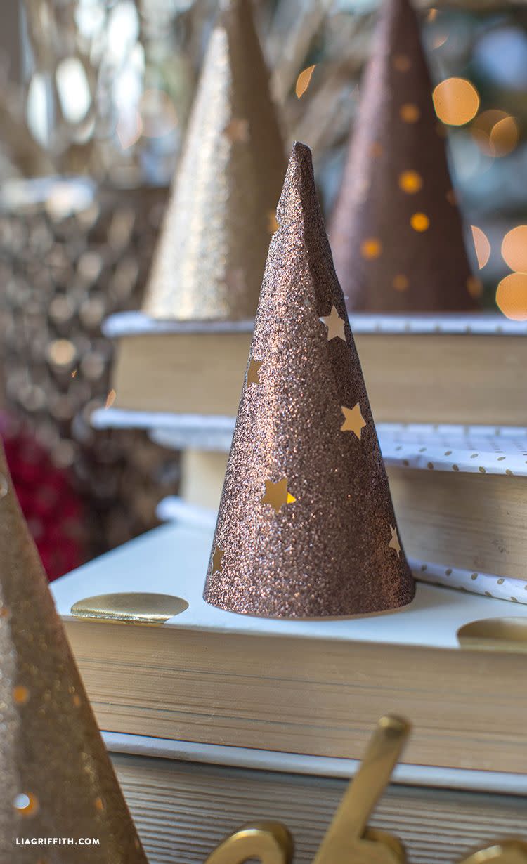 <p>It's Christmas, so literally anything and everything can be Christmas tree shaped. Turn paper cones into glittered trees and cut stars into them. Place a tea light inside and it'll function like a lantern.</p><p>Get the tutorial at <a href="https://go.redirectingat.com?id=74968X1596630&url=https%3A%2F%2Fliagriffith.com%2Fpaper-cone-lantern-christmas-tree%2F&sref=https%3A%2F%2Fwww.housebeautiful.com%2Fentertaining%2Fholidays-celebrations%2Fg999%2Fchristmas-home-decor%2F" rel="nofollow noopener" target="_blank" data-ylk="slk:Lia Griffith;elm:context_link;itc:0;sec:content-canvas" class="link ">Lia Griffith</a>.</p>