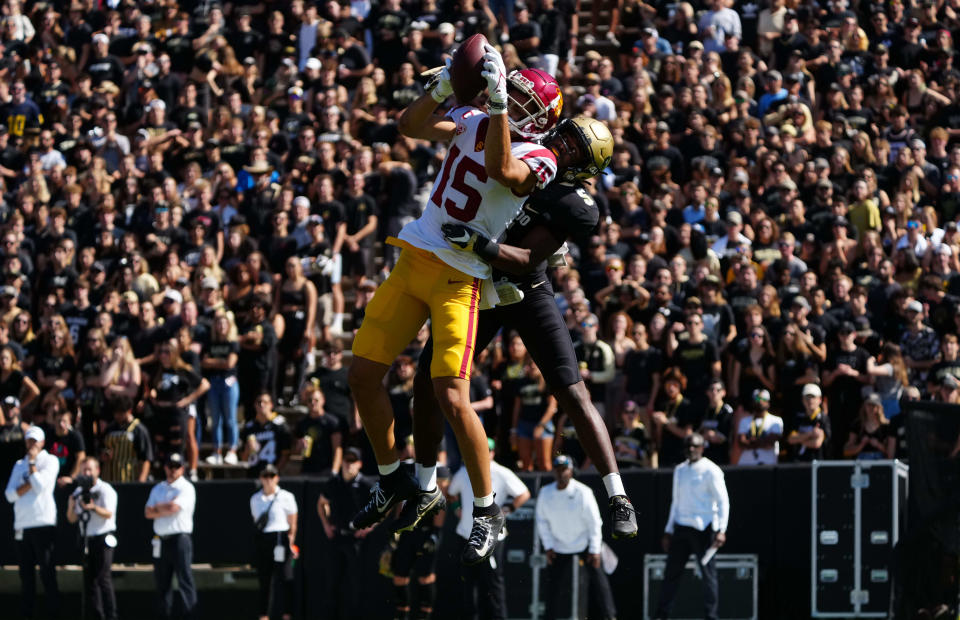 USC receiver Drake London pulls in a reception in front of Colorado safety Mark Perry at Folsom Field on Oct. 2.