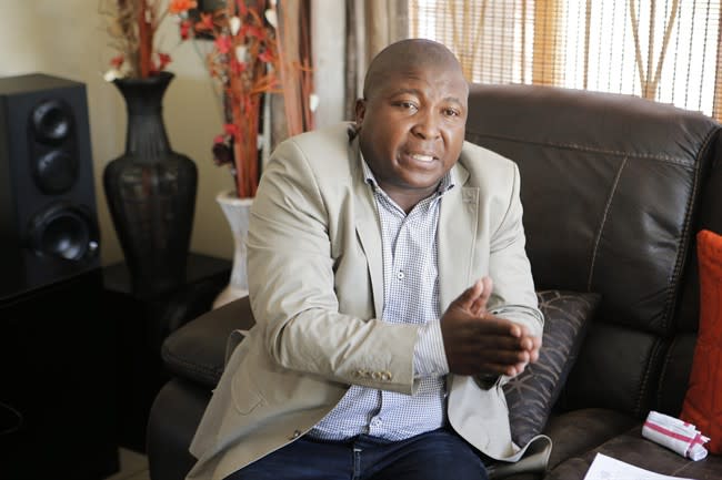 Thamsanqa Jantjie gestures at his home during an interview with the Associated Press in Johannesburg, South Africa,Thursday, Dec. 12, 2013. Jantjie, the man accused of faking sign interpretation next to world leaders at Nelson Mandela's memorial, told a local newspaper that he was hallucinating and hearing voices. (AP Photo/Tsvangirayi Mukwazhi)