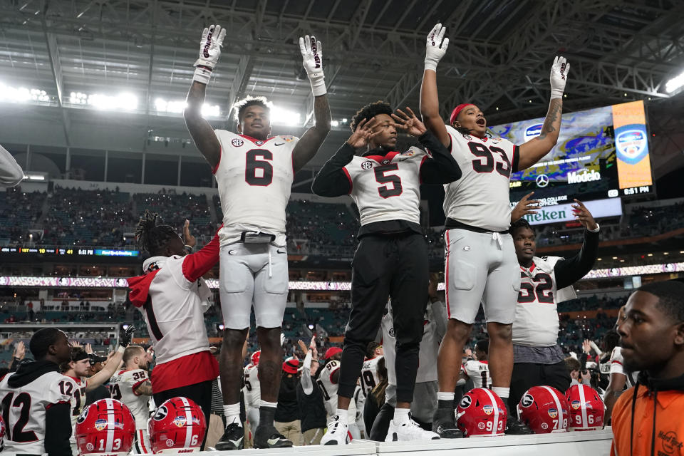 Georgia defensive lineman Tyrion Ingram-Dawkins (93) stands on the bench to sing a team song during the second half of Orange Bowl NCAA college football game against Florida State, Saturday, Dec. 30, 2023, in Miami Gardens, Fla. (AP Photo/Lynne Sladky)