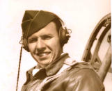 In this undated image provided by the Kriegshauser family showing Lt. John G. Kriegshauser sitting in the cockpit of a plane. On Friday Feb. 22, 2019 the U.S. and the Royal Air Force are set to honor Lt. John G. Kriegshauser and his crew, who decided to crash and die rather than take the chance of hitting a group of playing children on Feb. 22, 1944 when their stricken plane flew over Sheffield in England. (Kriegshauser family via AP)