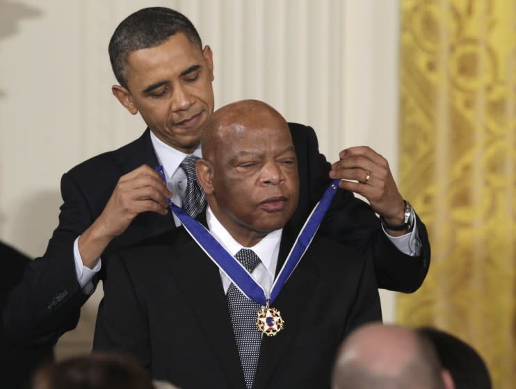FILE - In this Feb. 15, 2011, file photo, President Barack Obama presents a 2010 Presidential Medal of Freedom to Rep. John Lewis, D-Ga., during a ceremony in the East Room of the White House in Washington. Lewis announced Sunday, Dec. 29, 2019, that he has stage IV pancreatic cancer, vowing he will stay in office and fight the disease with the tenacity which he fought racial discrimination and other inequalities since the civil rights era. (AP Photo/Carolyn Kaster, File)
