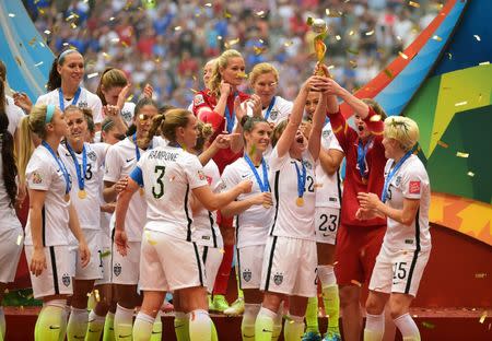 Jul 5, 2015; Vancouver, British Columbia, CAN; United States players react as they receive the FIFA Women's World Cup trophy after defeating Japan in the final of the FIFA 2015 Women's World Cup at BC Place Stadium. Credit: Anne-Marie Sorvin-USA TODAY Sports