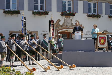 Alpenhorn players stand before U.S. President Barack Obama as he and German Chancellor Angela Merkel speak in the Bavarian village of Kruen, Germany June 7, 2015. REUTERS/Kevin Lamarque
