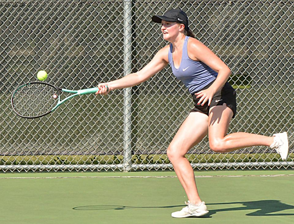 Watertown's Sophia Nichols reaches to hit a return shot during Tuesday's high school girls tennis dual against Milbank at the Highland Park courts. The Arrows won 9-0.