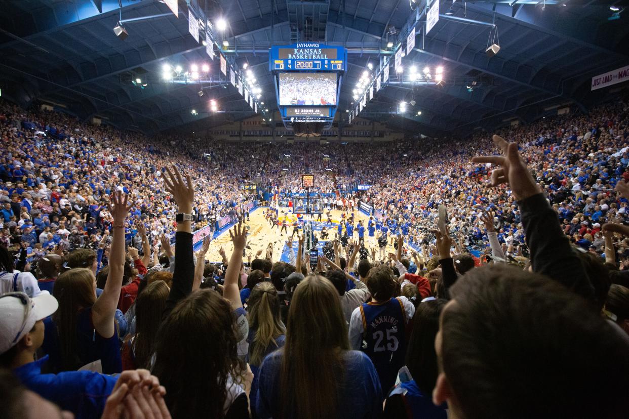 Kansas fans throw up newspapers as the starting lineup is announced before Tuesday's game against Oklahoma inside Allen Fieldhouse.