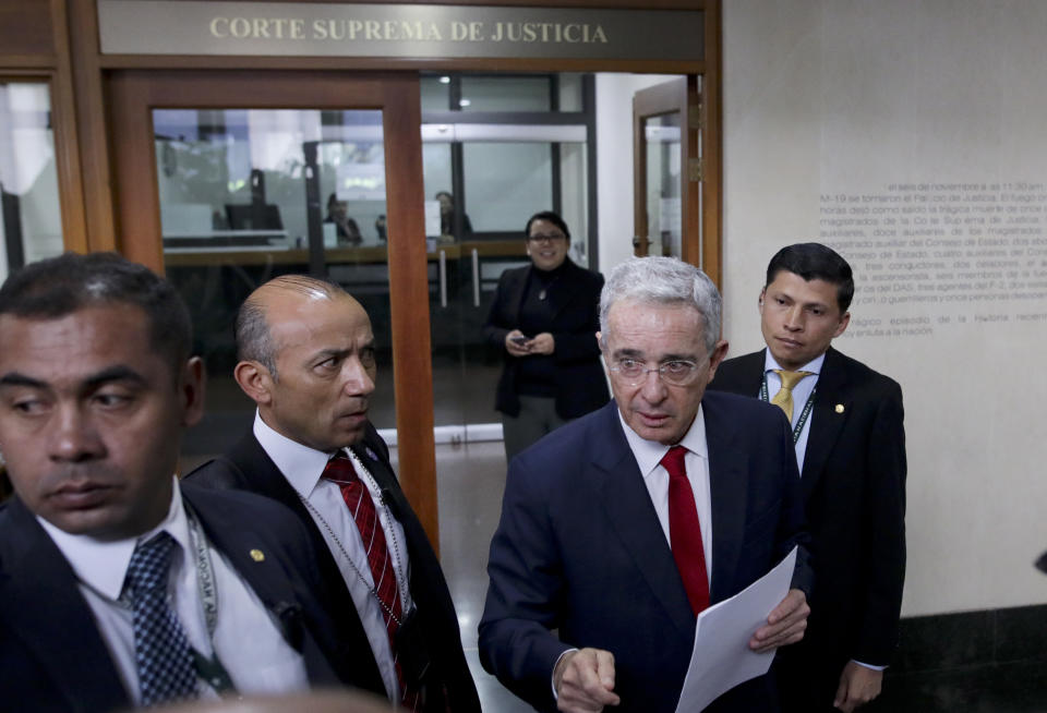 Senator and former president Alvaro Uribe arrives to the Supreme Court for questioning in an investigation for witness tampering charges in Bogota, Colombia, Tuesday, Oct. 8, 2019. Uribe is under investigation over allegations he made false accusations and tried to influence members of a former paramilitary group in a case he started by making similar accusations against leftist Senator Ivan Cepeda. (AP Photo/Ivan Valencia)