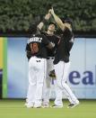 <p>Miami Marlins left fielder Marcell Ozuna, left, center fielder Christian Yelich, center, and right fielder Giancarlo Stanton, right, point skywards after a baseball game against the New York Mets, Monday, Sept. 26, 2016, in Miami. The Marlins defeated the Mets 7-3. The players wore jerseys in honor of pitcher Jose Fernandez who died in a boating accident early Sunday. (AP Photo/Lynne Sladky) </p>