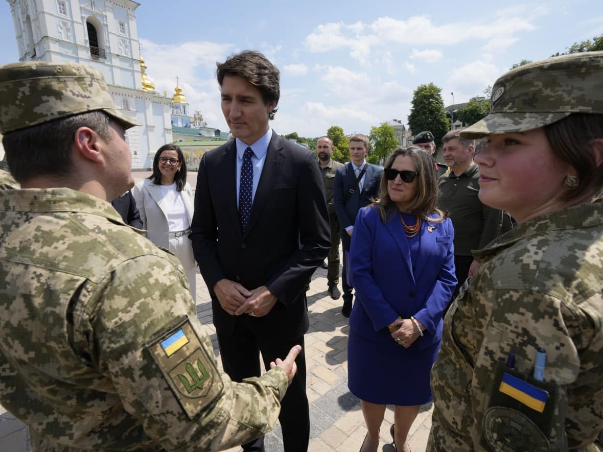 Canadian Prime Minister Justin Trudeau, accompanied by Chrystia Freeland, the deputy prime minister and finance minister, meets with soldiers in Kyiv on Saturday.  (Frank Gunn/The Canadian Press - image credit)