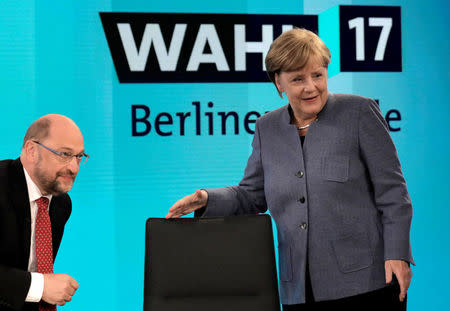 German Chancellor Angela Merkel, head of the Christian Democratic Party CDU, talks to Katrin Goering-Eckardt of the Green party as her challenger Martin Schulz, head of the Social Democratic Party SPD, left, looks on prior to a TV chat show in Berlin, Germany, September 24, 2017. REUTERS/Gero Breloer/POOL