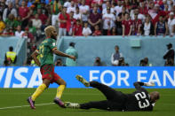 Cameroon's Eric Maxim Choupo-Moting, left, scores his side's third goal during the World Cup group G soccer match between Cameroon and Serbia, at the Al Janoub Stadium in Al Wakrah, Qatar, Monday, Nov. 28, 2022. (AP Photo/Francisco Seco)