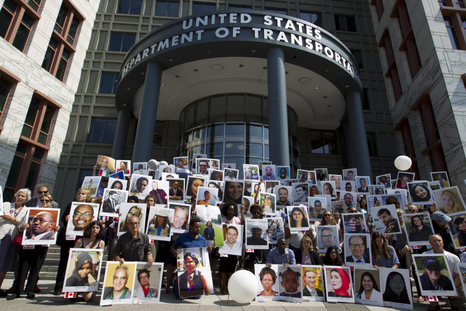 Demonstrators hold pictures of the plane crash victims during a vigil on the six-month anniversary of the crash of a Boeing 737 Max 8, killing 157 people, in Ethiopia on March 10, which has resulted in the grounding hundreds of the planes worldwide, outside of the Department of Transportation, Tuesday, Sept. 10, 2019 in Washington. (AP Photo/Jose Luis Magana)