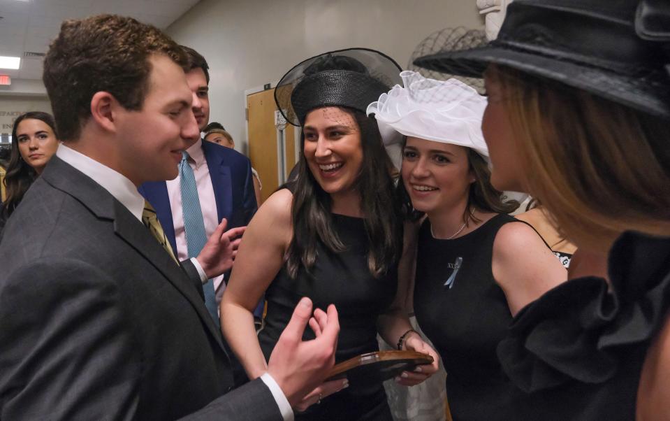 April 7, 2023; Tuscaloosa, AL, USA;  Marcella Martinez, center, the outstanding senior, is congratulated by friends for her recognition during the Tapping on the Mound academic awards ceremony held in the English building due to weather Friday at the University of Alabama.