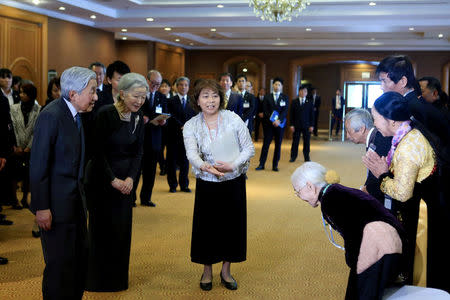 Nguyen Thi Xuan, 92, married to former Japanese soldier, greets Japanese Emperor Akihito (L) and Empress Michiko (2-L) as they meet with family members of Japanese veterans living in Vietnam, at a hotel in Hanoi, Vietnam, March 2, 2017. REUTERS/Minh Hoang/Pool