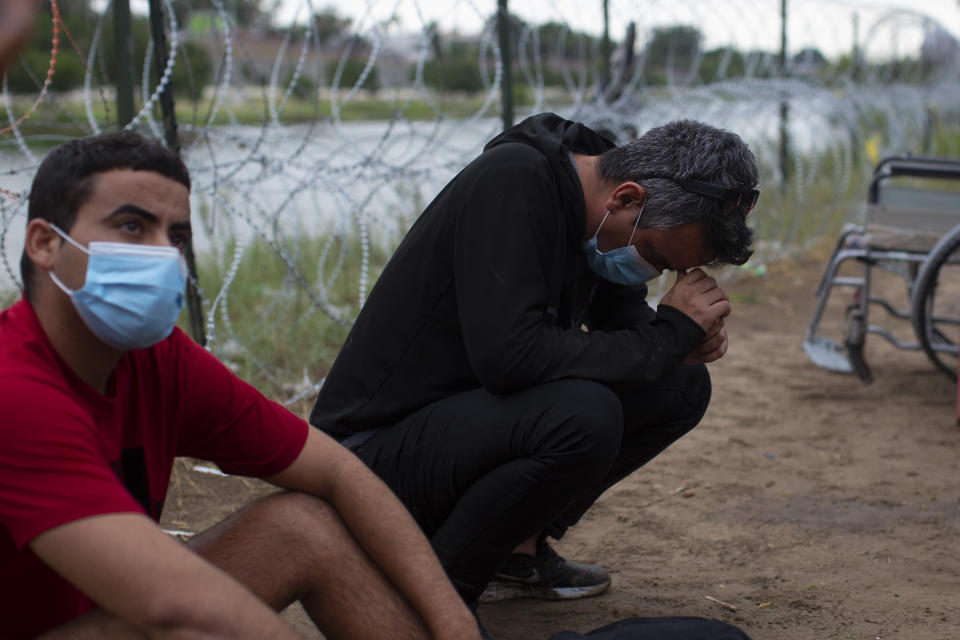 Migrants from Cuba rest after crossing the Rio Grande river in Eagle Pass, Texas, Sunday May 22, 2022. Little has changed in what has quickly become one of the busiest corridors for illegal border crossings since a federal judge blocked pandemic-related limits on seeking asylum from ending Monday. (AP Photo/Dario Lopez-Mills)