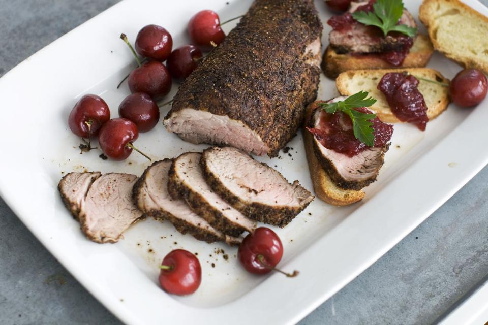 In this image taken on Jan. 28, 2013, cherry-topped coffee-roasted pork tenderloin is shown served on a platter in Concord, N.H. (AP Photo: Matthew Mead)