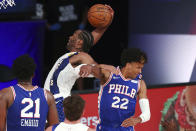 Philadelphia 76ers guard Matisse Thybulle (22) fouls Indiana Pacers forward T.J. Warren, who grabs a rebound during the third quarter of an NBA basketball game Saturday, Aug. 1, 2020, in Lake Buena Vista, Fla. (Kim Klement/Pool Photo via AP)