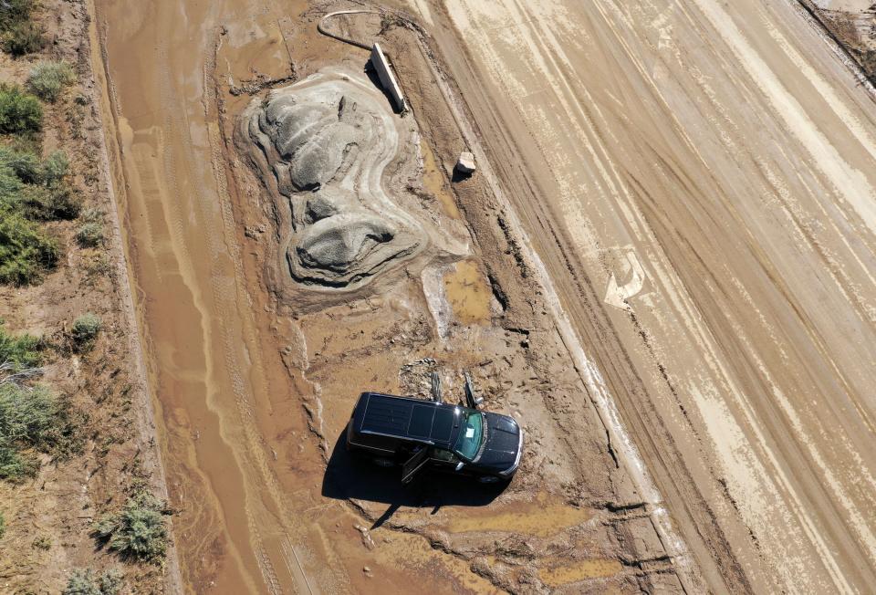 A vehicle is surrounded by mud near the intersection of 1300 East and Highland Drive after flooding in Draper on Friday, Aug. 4, 2023. Draper Mayor Troy Walker declared a state of emergency due to flooding. | Kristin Murphy, Deseret News