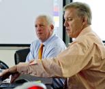 In this photo provided by the Denver Broncos, head coach John Fox, rear, and executive vice president of football operations John Elway, right, monitor the NFL football draft in the Broncos' draft room, Thursday, April 26, 2012, in Englewood, Colo. (AP Photo/Denver Broncos, Eric Lars Bakke)