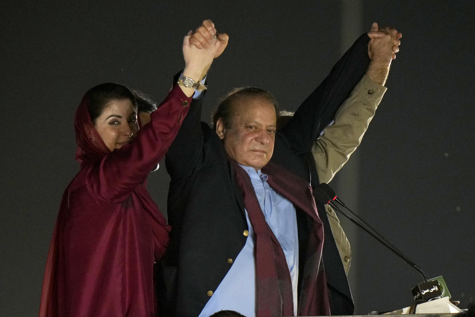 Pakistan's former Prime Minister Nawaz Sharif, center with his daughter Maryam Nawaz, left, wave to his supporters upon his arrival to address a welcoming rally, in Lahore, Pakistan, Saturday, Oct. 21, 2023. Sharif returned home Saturday on a special flight from Dubai, ending four years of self-imposed exile in London as he seeks to win the support of voters ahead of parliamentary elections due in January. (AP Photo/Anjum Naveed)