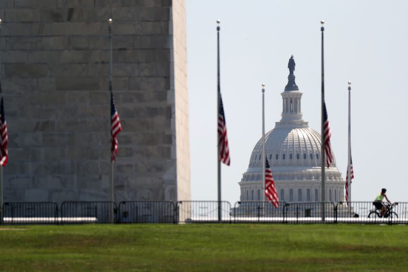 Flags surrounding the Washington Monument are lowered to half-staff following the death of Congressman John Lewis, on the National Mall in Washington