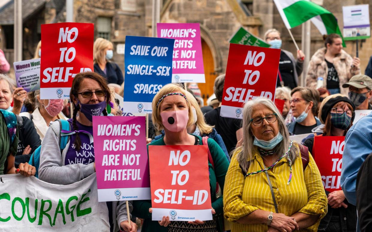 Protesters supporting women's rights demonstrate outside the Scottish Parliament at Holyrood in Edinburgh - Alamy