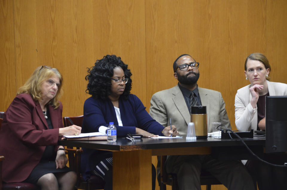 Defendant Willie Cory Godbolt hears the jury's verdict of guilty on all 12 counts Tuesday, Feb. 25, 2020 on Day 10 of his capital murder trial at the Pike County Courthouse in Magnolia, Miss. The jury deliberated for just over two hours. Pictured are, from left: defense attorney Allison Steiner, mitigation specialist Lela Hubbard, Godbolt and defense attorney Katherine Poor. Godbolt, 37, is on trial, for the May 2017 shooting deaths of eight people in Brookhaven. (Donna Campbell/The Daily Leader via AP, Pool)