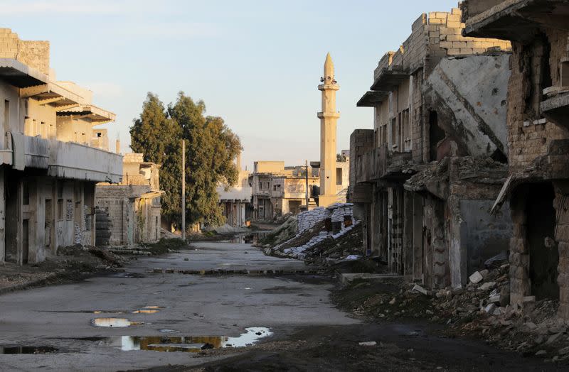 Damaged buildings are pictured along a deserted street in the rebel-held town of Tadef