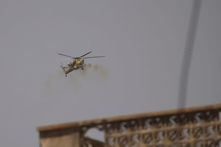 A helicopter of the Iraqi Army fires against Islamic State positions in western Mosul, Iraq May 27, 2017. REUTERS/Alkis Konstantinidis