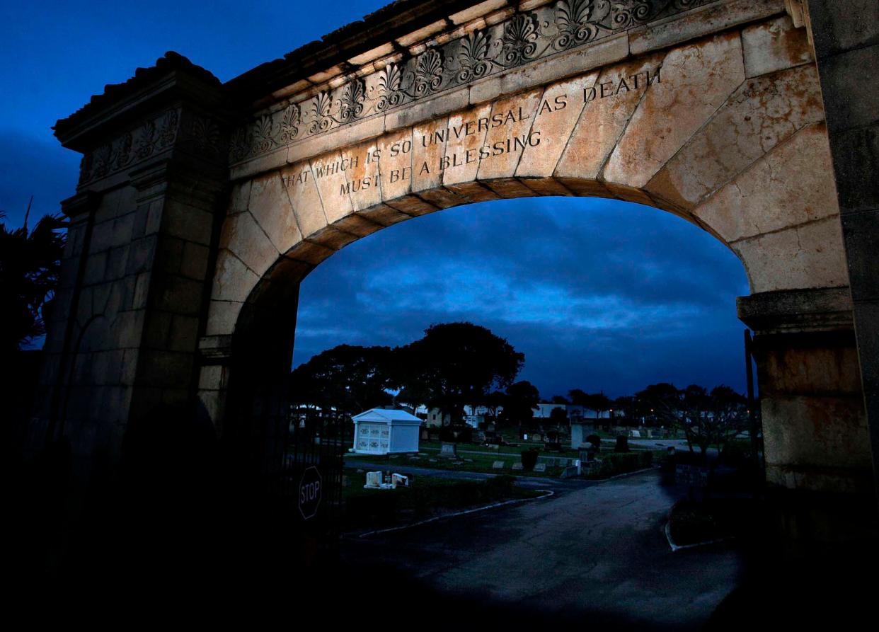 The gates to Woodlawn Cemetery, which opened in January 1905. The phrase above the entryway says, 'That which is so universal as death must be a blessing." The saying was in bronze letters on the original iron gates, which were removed when Dixie Highway was widened. The current arch was built in 1925.