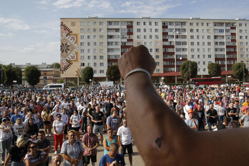 Belarusian miners gather for a rally in Salihorsk, about 120 km (75 miles) from Minsk, Belarus, Tuesday, Aug. 18, 2020. Factory workers in Belarus continued to strike on Tuesday, turning up pressure on the country's authoritarian leader to step down after winning an election they say was rigged. (AP Photo/Dmitri Lovetsky)