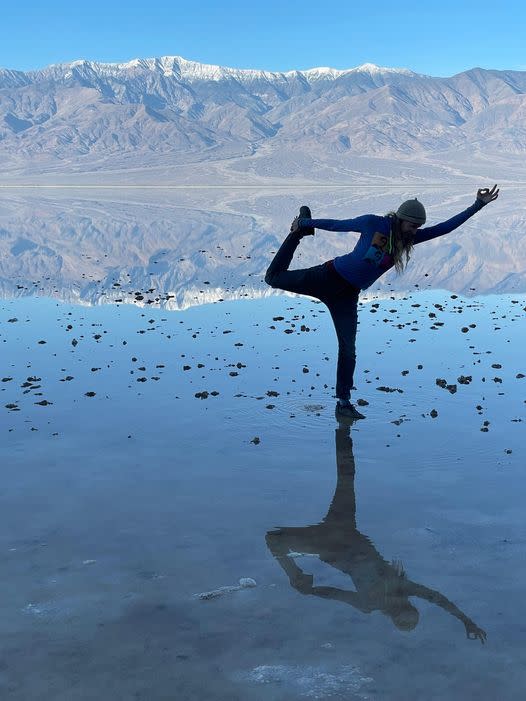 A woman does a standing yoga pose at “Lake Manly” at Badwater Basin on Christmas Eve. (Photo: National Park Service)