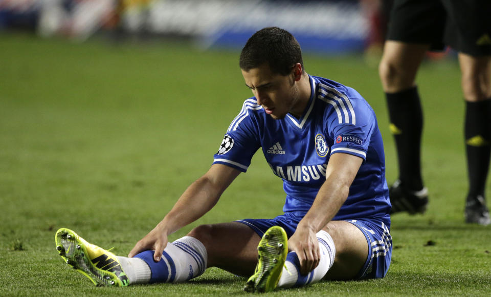 Chelsea's Eden Hazard looks at his boots as he sits on the ground following a fall during the Champions League semifinal second leg soccer match between Chelsea and Atletico Madrid at Stamford Bridge stadium in London, Wednesday, April 30, 2014. (AP Photo/Matt Dunham)