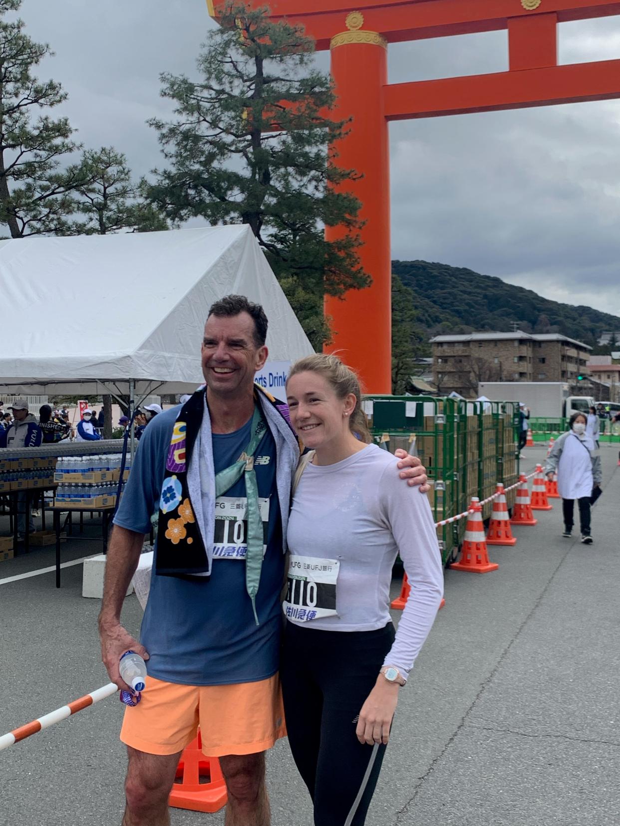 Margie Cullen (right) and John Cullen at the finish line of the Kyoto Marathon. They ran 3:00:01 as a team of two.