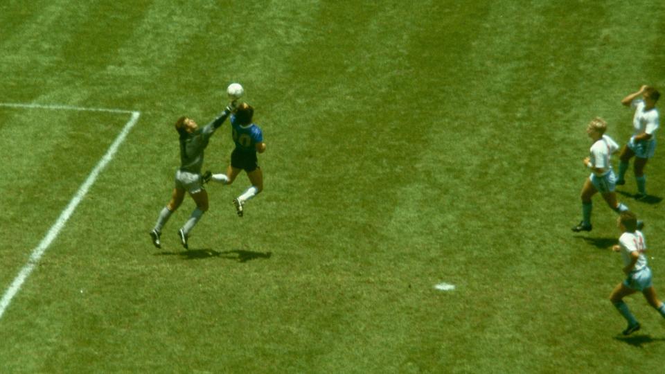 Argentina player Diego Maradona outjumps England goalkeeper Peter Shilton to score with his 'Hand of God' goal as England defenders Kenny Sansom (top) Gary Stevens (c) and Terry Fenwick look on during the 1986 FIFA World Cup Quarter Final at the Azteca Stadium