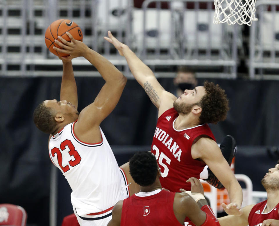 Ohio State forward Zed Key, left, goes up for a shot against Indiana forward Race Thompson during the first half of an NCAA college basketball game in Columbus, Ohio, Saturday, Feb. 13, 2021. (AP Photo/Paul Vernon)