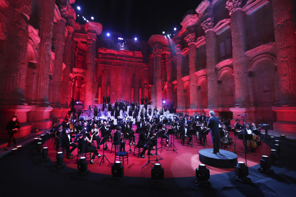 Musicians from the Lebanese Philharmonic Orchestra perform during a concert in the ancient northeastern city of Baalbek, Lebanon, Sunday, July 5, 2020. Dubbed "an act of cultural resilience," the concert aims to send a message of unity and hope to the world amid the coronavirus pandemic and an unprecedented economic and financial crisis in Lebanon. For the first time since the Baalbek International Festival was launched in 1956, this year's concert is being held without an audience, in line with strict COVID-19 guidelines. Instead, it is being broadcast live on local and regional TV stations and live-streamed on social media platforms. (AP Photo/Bilal Hussein)