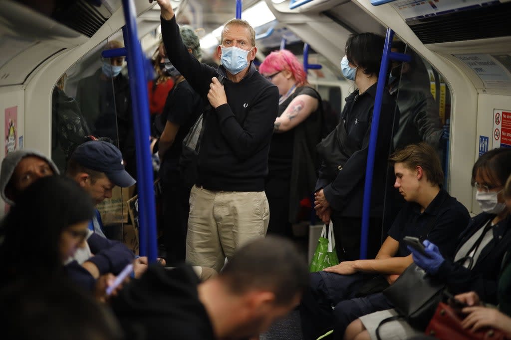 Commuters in masks on the London Underground  (AFP via Getty Images)