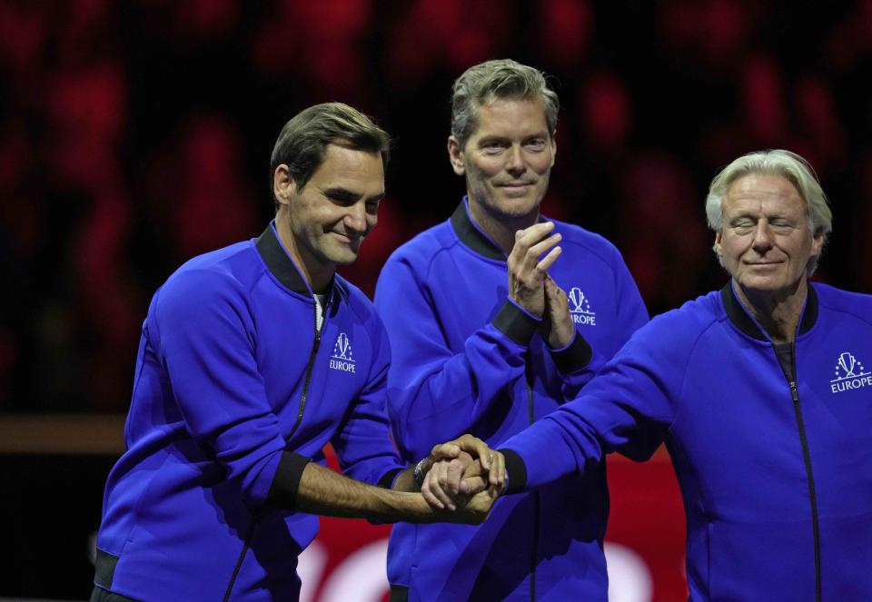 Team Europe's Captain Bjorn Borg, right, holds the hands of his player Roger Federer at the end of the Laver Cup tennis tournament at the O2 arena in London, Sunday, Sept. 25, 2022. (AP Photo/Kin Cheung)