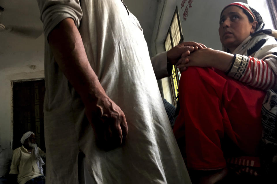 A Kashmiri man comforts his wife inside the waiting room of Agra Central Jail as they wait for their turn to meet their son in Agra, India, Friday, Sept. 20, 2019. Families from the Himalayan region of Kashmir have traveled nearly 1,000 kilometers (600 miles) in sweltering heat to meet relatives being held in an Indian jail in the city of Agra. At least 4,000 people, mostly young men, have been arrested in Indian-held Kashmir since the government of Prime Minister Narendra Modi imposed a security clampdown and scrapped the region’s semi-autonomy on Aug. 5, according to police officials and records reviewed by AP. (AP Photo/Altaf Qadri)
