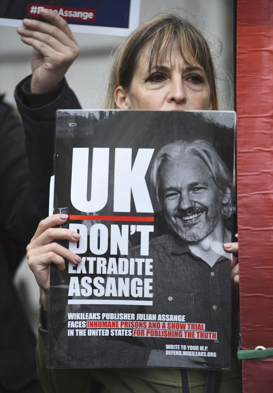 A supporter of Wikileaks founder Julian Assange demonstrates oustide Westminster Magistrates' Court in London where Assange is expected to appear as he fights extradition to the United States on charges of conspiring to hack into a Pentagon computer, in London, Monday, Oct, 21, 2019. U.S. authorities accuse Assange of scheming with former Army intelligence analyst Chelsea Manning to break a password for a classified government computer. (Kirsty O'Connor/PA via AP)