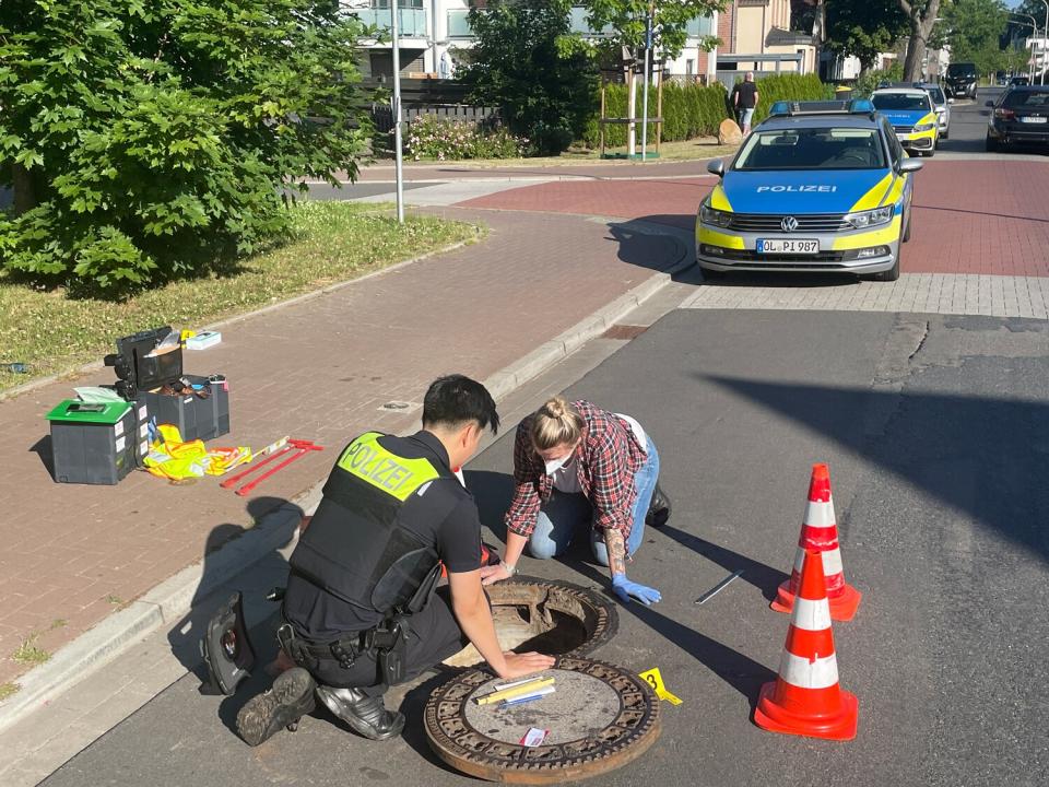 Police officers examine a storm drain. The eight-year-old boy from Oldenburg, who has been missing for eight days, has been found alive in a storm drain. The mentally handicapped boy named Joe was last seen on June 17. He is currently being cared for in a hospital.