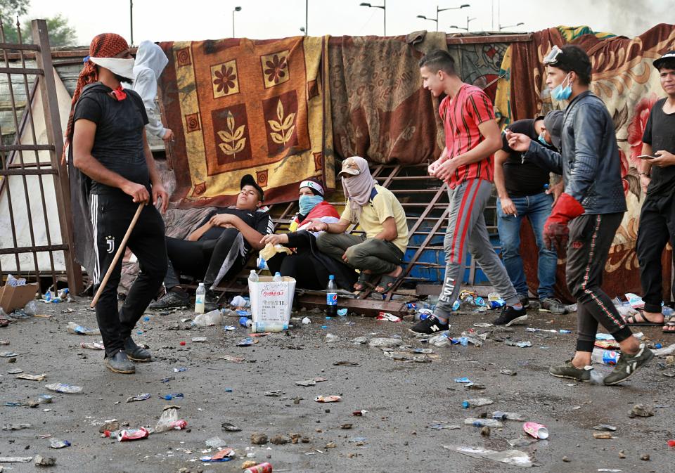 Anti-government protesters take a rest in Tahrir Square during a demonstration in Baghdad, Iraq, Sunday, Oct. 27, 2019. Protests have resumed in Iraq after a wave of anti-government protests earlier this month were violently put down. At least 149 people were killed in a week of demonstrations earlier in October. (AP Photo/Hadi Mizban)