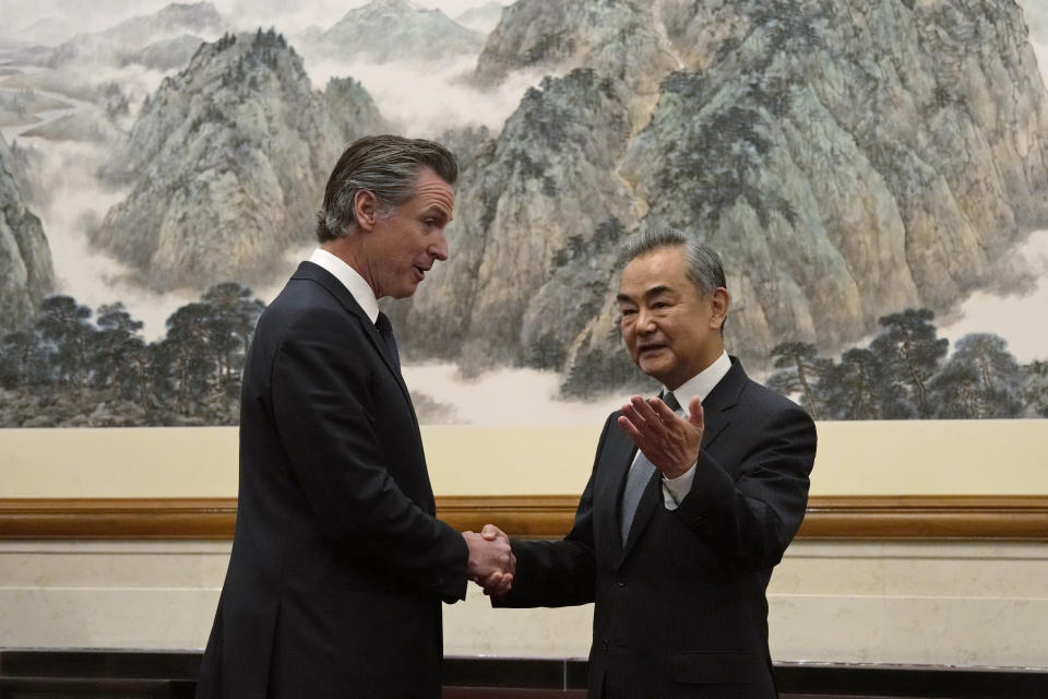 FILE - California Gov. Gavin Newsom, left, shakes hands with Chinese Foreign Minister Wang Yi during a meeting at the Diaoyutai State Guest House in Beijing, on Oct. 25, 2023. Gavin Newsom's trip to China, with the stated goal of working together to fight climate change, resulted in a surprise meeting with leader Xi Jinping and was filled with warm words and friendliness not seen in years in the China- U.S. relationship. (AP Photo/Ng Han Guan, File)