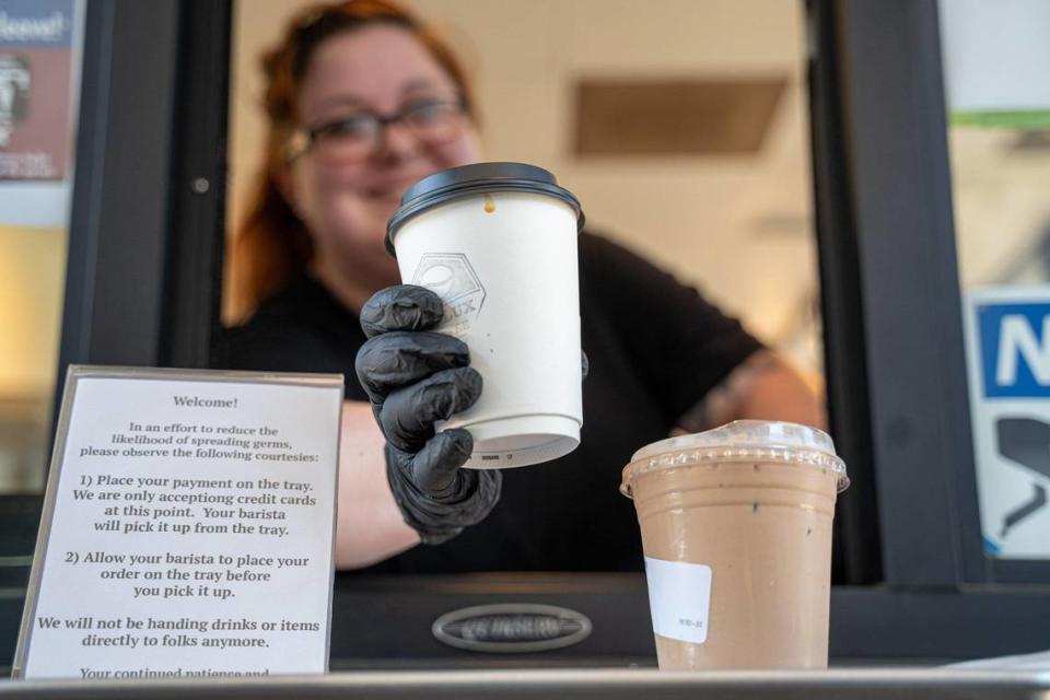 CupLux Coffee has implemented a system at their drive-thru with a tray stand so that there is no person-to-person contact during the food exchange in response to COVID-19.